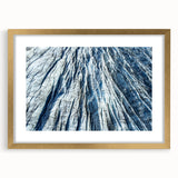 Textured art depicting abstract frost patterns in gray and white, framed in gold, suitable for bedroom decor.