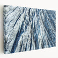 Close-up of frost patterns on ice in muted blue and white tones, printed on a large stretched canvas.
