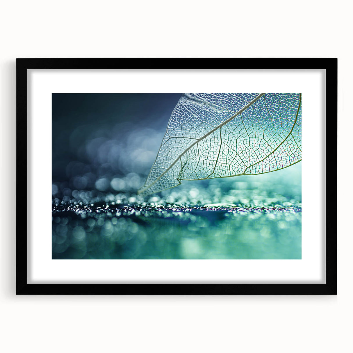 Extra large abstract art print of colorful, textured leaves, framed in black, ideal for living room decor.