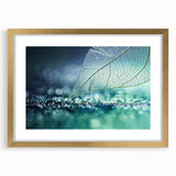 Extra large abstract art print featuring close-up leaves in textured green and gold tones, framed in gold.