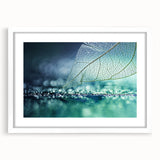 Abstract art print of close-up leaves in muted green tones, framed with a white mat, ideal for bedroom or dining room decor.