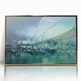 Large art print of close-up leaves in gold frame, featuring mid-century modernist style with muted green tones.