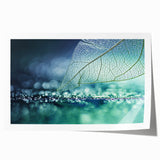 Close-up image of green leaves on a rolled print, with soft green tones.