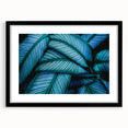 Extra large abstract art print of vibrant, colorful leaves on textured canvas, framed in black, ideal for living room decor.