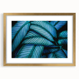 Extra large abstract art print featuring close-up textured leaf designs in green tones, framed in gold.