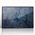 Large abstract wall art featuring close-up leaves in green and yellow tones on black acrylic, framed.