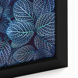 Close-up of textured black wall art featuring colorful leaves on a large framed canvas, suitable for living room decor.