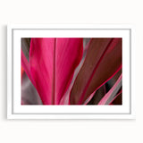 Abstract art print featuring close-up leaves in green and yellow tones, framed with a white mat, ideal for dining room decor.