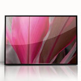 Large abstract wall art featuring close-up leaves in muted green and brown shades, presented in a black acrylic frame.