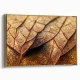 Framed canvas depicting close-up of leaves in gold and black tones, ideal for bedroom wall art.