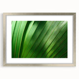 Abstract textured art print of close-up leaves in silver frame, featuring green and brown hues, ideal for bedroom art.