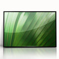 Large abstract wall art featuring close-up leaves design in green tones on framed acrylic, suited for modern home decor.
