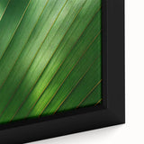 Close-up of textured leaves in black with vibrant color accents on a large framed canvas, suitable for living room decor.