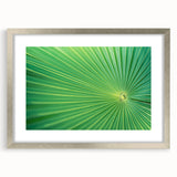 Textured art of abstract leaves in muted green and silver, framed with a mat in a silver frame, suitable for bedroom decor.