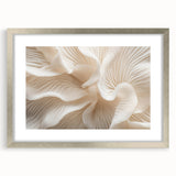 Textured abstract art print of overlapping leaves in muted green shades, framed in silver, ideal for bedroom art.