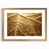 Extra large framed abstract art print featuring close-up textured leaves in gold and green tones.