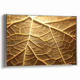 Framed canvas featuring close-up of leaves in muted green and brown tones.