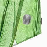 Close-up of leaves in green and yellow hues on acrylic glass, ideal for dining room art in a mid-century modernist style.