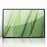Large abstract wall art featuring close-up leaf designs in green and brown, framed in black acrylic.