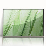 Mid-century modernist art depicting close-up leaves in green and silver tones on a framed acrylic.