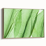 Framed canvas featuring a close-up of leaves in black and gold tones, ideal for bedroom wall art.
