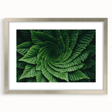 Textured art print of abstract leaves in muted green and silver, framed with mat, ideal for bedroom wall decor.
