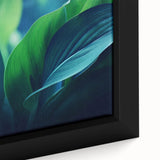 Close-up of black framed canvas featuring textured colorful leaves, ideal for extra large living room wall art.