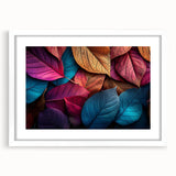 Abstract art print of close-up leaves in muted green and white, framed with a white mat.