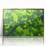 Mid-century modernist art of leaves in silver frame, utilizing a palette of green and brown, ideal for nursery wall decor.