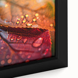 Close-up of textured black wall art featuring colorful leaves design on a framed canvas.