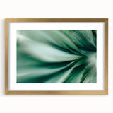 Extra large abstract art print featuring close-up leaf designs in green and gold tones, framed with a gold mat.