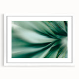 Abstract art print featuring close-up green leaves, in a white frame with mat, ideal for dining room decor.