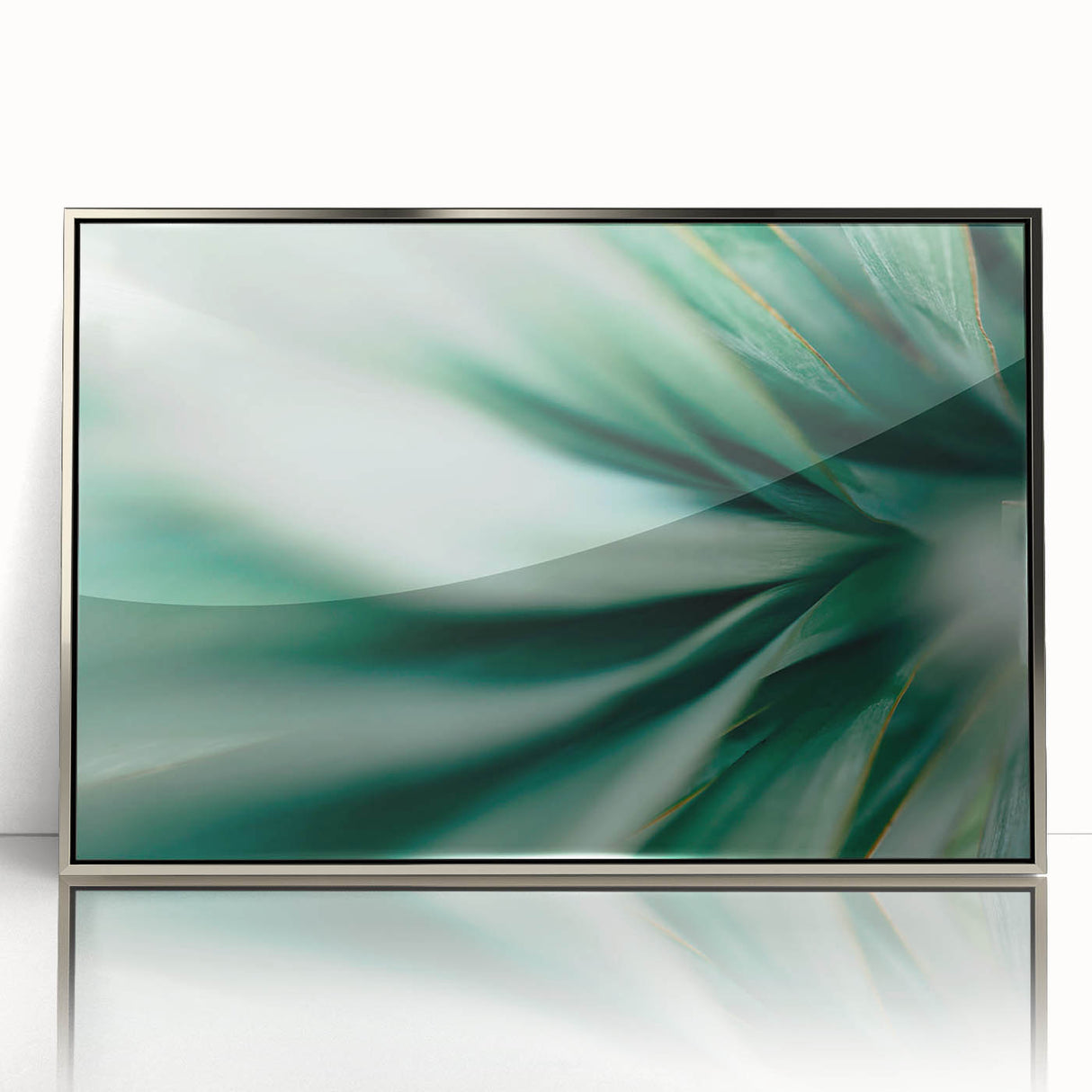 Mid-century modernist art of silver-framed acrylic leaves in muted green tones, suitable for nursery wall art.
