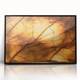 Large abstract wall art featuring close-up leaves in muted green and black tones on a framed acrylic.