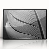 Framed acrylic print featuring large abstract wall art of overlapping leaves in green and blue tones.