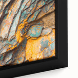 Close-up of textured black wall art featuring colorful natural elements on a framed canvas, ideal for living room decor.