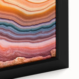Close-up of black wall art featuring vibrant, textured floral elements on a framed canvas, ideal for living room decor.