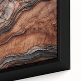 Close-up of black textured wall art featuring colorful natural elements on a large framed canvas.