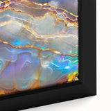 Close-up of textured black wall art featuring colorful natural elements on a framed canvas, ideal for living room decor.
