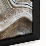 Close-up of textured black wall art featuring colorful natural elements on a large framed canvas.