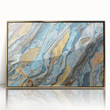 Large art print of a close-up nature scene with leaf patterns in muted green and gold tones on framed acrylic.