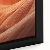 Close-up of textured black wall art featuring colorful natural elements on a framed canvas, ideal for living room decor.