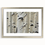 Textured art depicting abstract tree close-ups in muted green and brown, framed in silver, ideal for bedroom decor.