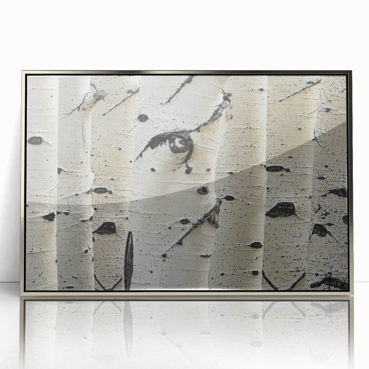Mid-century modernist art featuring close-up of trees in muted green and brown tones on a silver-framed acrylic print.