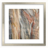 Textured art print of abstract trees in muted green and brown tones on a silver-framed canvas, ideal for bedroom decor.
