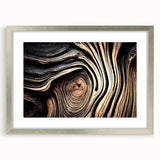 Textured art print of abstract trees in muted green and brown tones on a silver-framed canvas, suitable for bedroom decor.