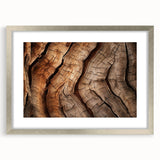 Textured art depicting close-up tree textures in muted earth tones, framed with a silver mat, suitable for bedroom ambiance.