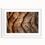 Abstract art print of close-up tree branches in muted green and brown tones, framed in white.