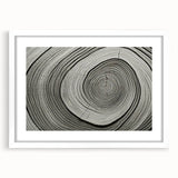 Abstract art print of close-up tree branches in grayscale, framed in white, suitable for bedroom or dining room decor.