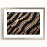 Textured art print of abstract trees in muted green and brown, framed in silver, ideal for bedroom wall decor.